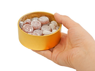 Fruit citrus cherry candy sweets in a jar metal in hand isolated