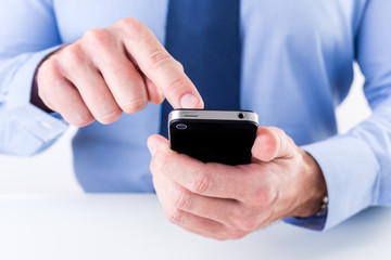 Businessman hands using smart phone. Shallow depth of field.