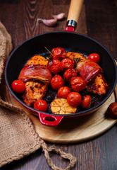 chicken breast wrapped in parma ham with cherry tomatoes