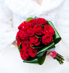 wedding saturate red rose bouquet in hands of bride