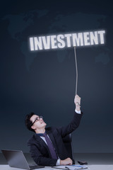 Male worker pulling an investment text