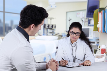 Fototapeta premium Practitioner write prescription for male patient