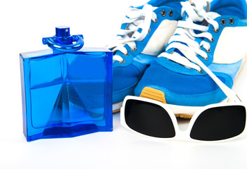Bottle spray of sports men perfume, sneakers, sunglasses on whit