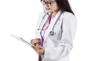 Young dentist using tablet in studio