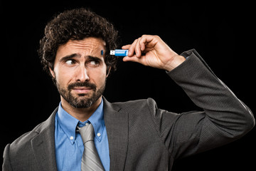 Man plugging a memory stick in his head
