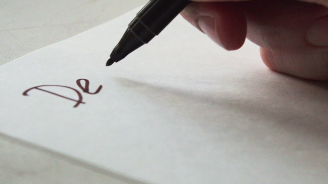 Writing the words of a letter Dear Mommy