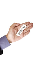 Hand Holding Paper With Believe Text