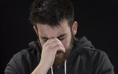 Worried Goatee Young Man with Hand on Face