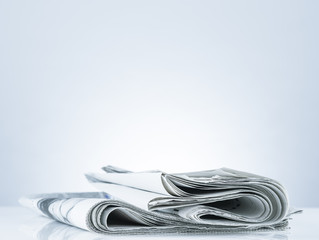Folded newspaper.On blank desk.
