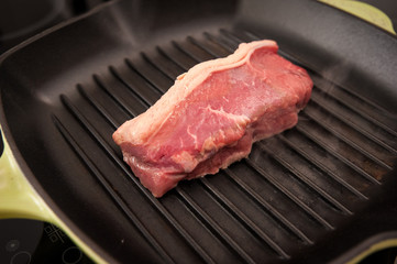 Rare beef rump steak on a griddle pan