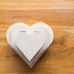 wood box shaped heart on brown wooden background