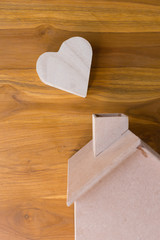wood box shaped heart on brown wooden background