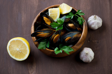 Steamed mussels with parsley, lemon and garlic, high angle view