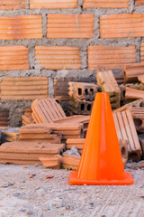 construction cone in construction site with bricks