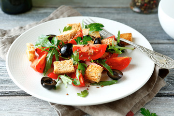 Fresh salad with tomatoes and croutons on a plate