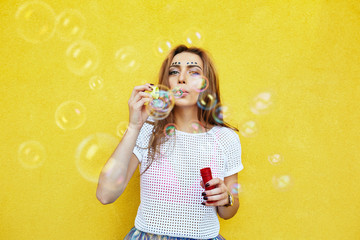 Young woman portrait blowing soap bubbles - Powered by Adobe