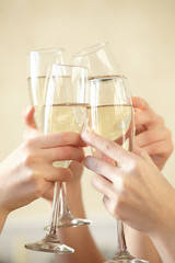 Glasses of champagne in female hands on a party