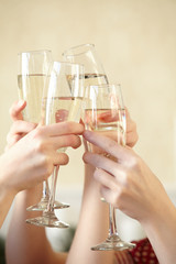 Glasses of champagne in female hands on a party