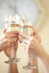 Glasses of champagne in female hands on a party