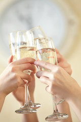 Glasses of champagne in female hands on a party