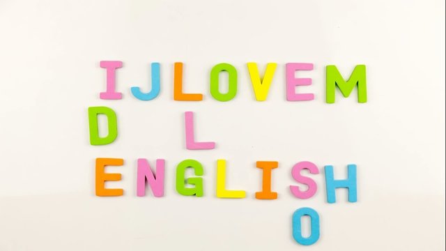 Alphabet magnets being taken away to form I Love English