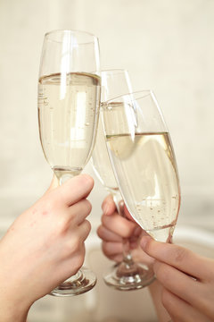 Glasses of champagne in female hands on a party