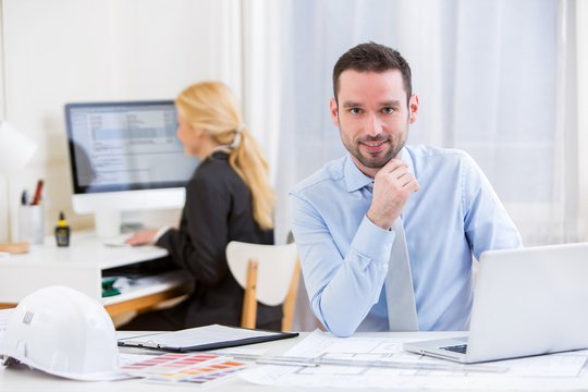 Young attractive engineer working at the office