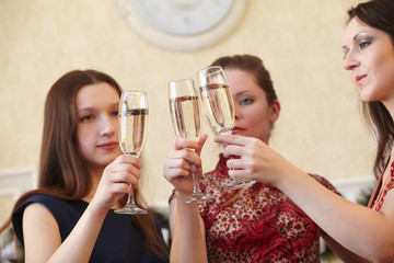 beautiful girls at a Christmas party with glasses of champagne