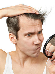 Man with mirror looking at his hair