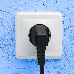 Wall plug socket on cracked wall