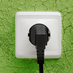 Wall plug socket on cracked wall