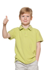 Handsome young boy shows his thumb up