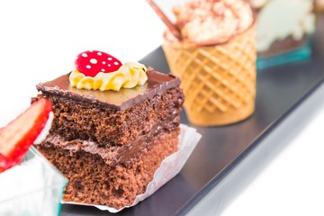 delicious chocolate cake near little coffee and strawberry cakes