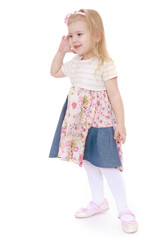 Adorable little girl holding a hand in front of face.