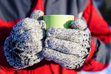 Closeup of man hands holding a cup of hot drink