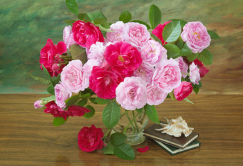 Still life with red and pink roses bunch and  books