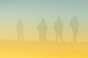 People silhouettes in fog