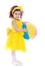 Adorable little girl in a yellow dress