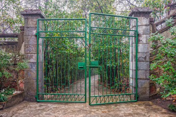 The green iron gate and the path way to park