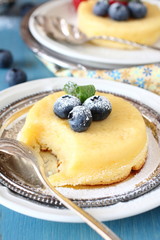Lemon Surprise Pudding cake  served with berries
