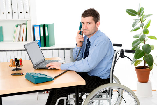 man in wheelchair is working