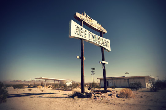 Historic vintage restaurant and gas station sign on old Route 66 in the desert, California, USA
