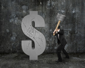 businessman holding hammer hitting cracked dollar sign with mott © TSUNG-LIN WU