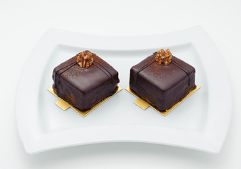 Chocolate sponge cakes on white plate