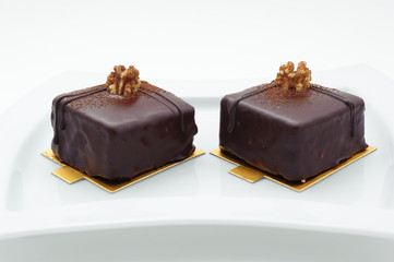 Chocolate sponge cakes on white plate