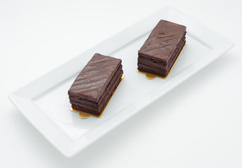 Chocolate sponge cakes on white plate