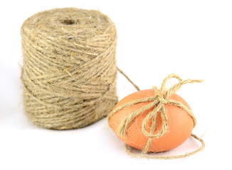 egg tied with twine