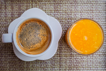 coffee and fresh orange juice on table