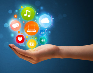 Multimedia icons in the hand of a woman