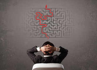 Business man looking at a maze and the way out